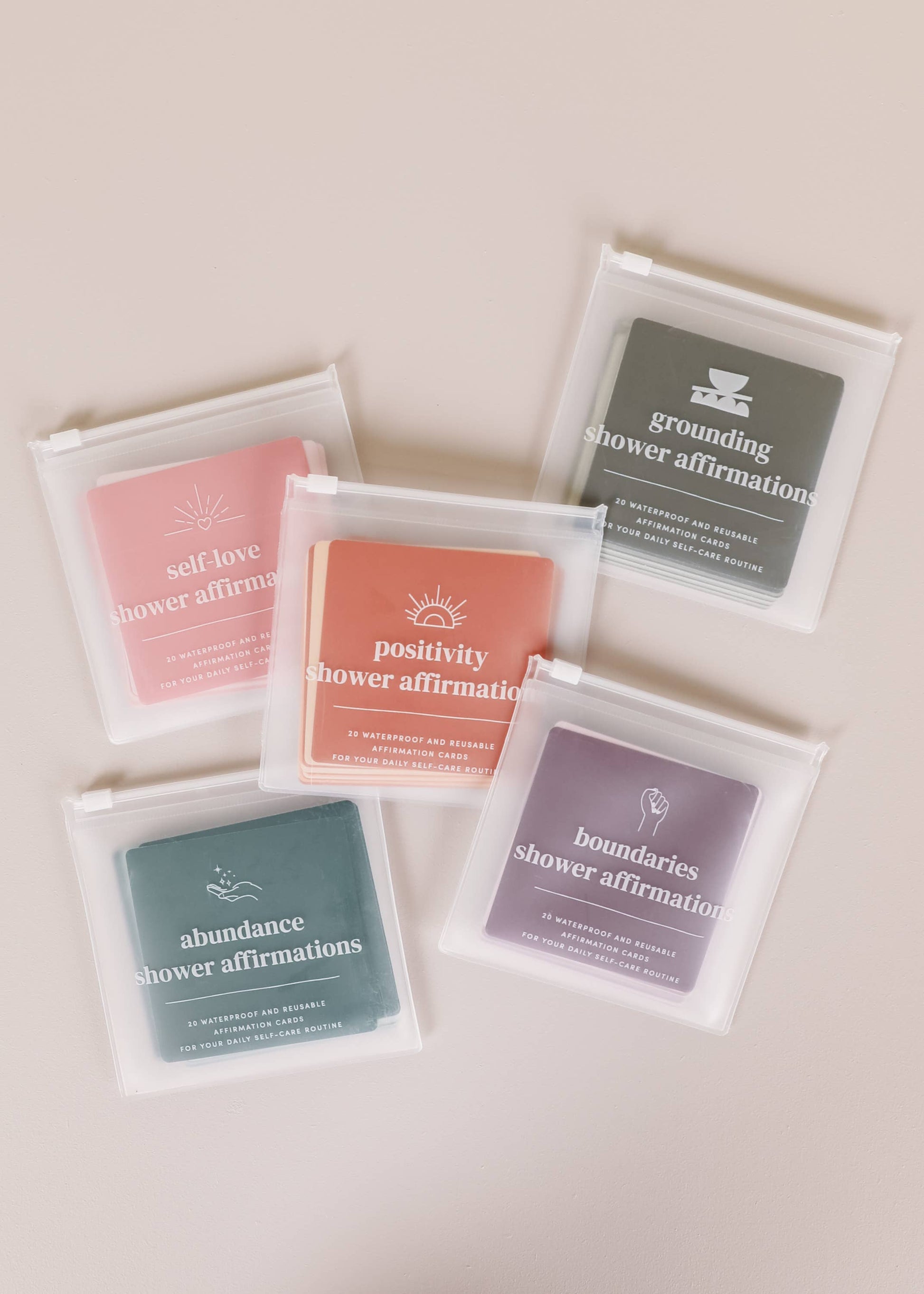 Collection of shower affirmation packets on a light background