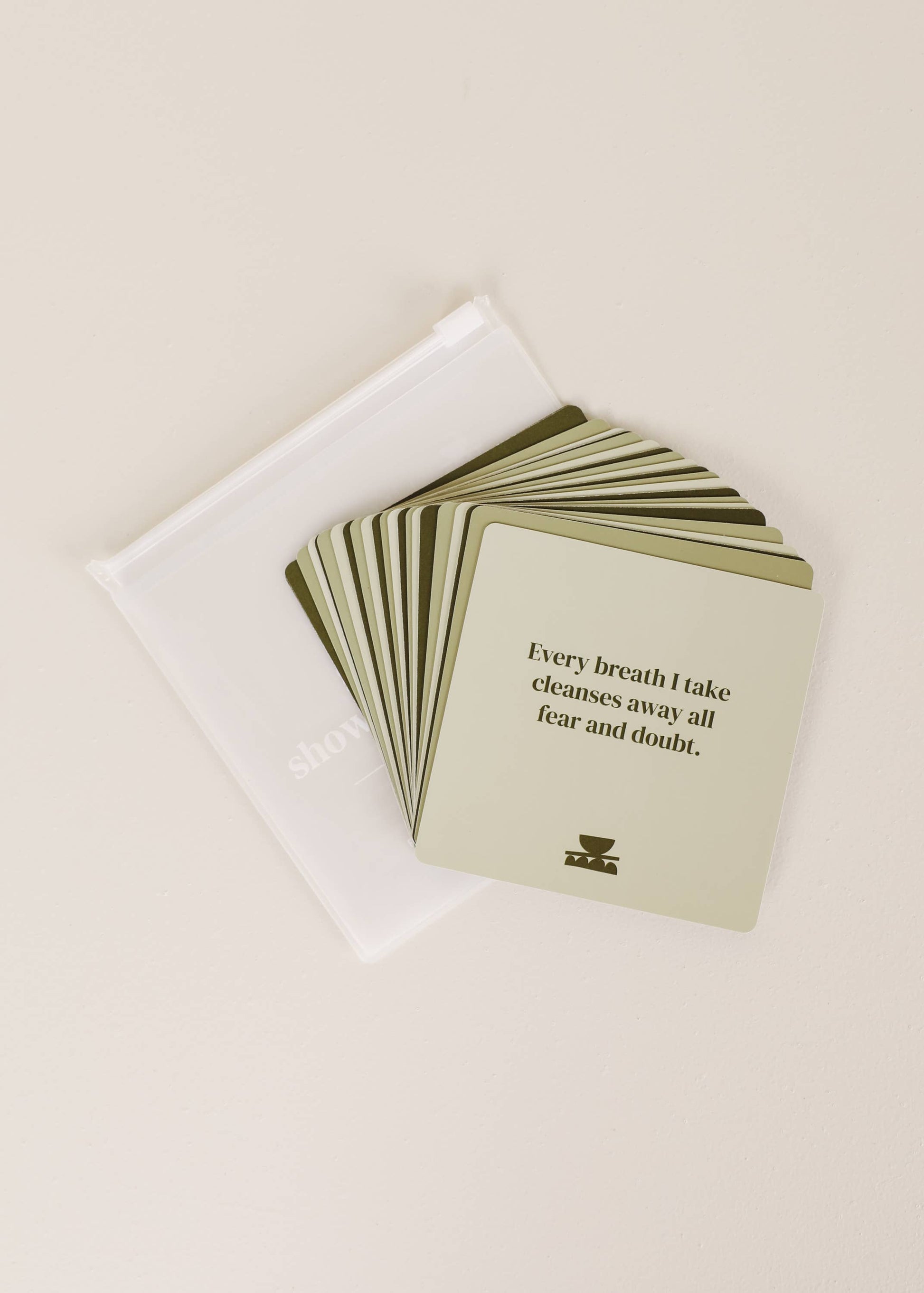 Stack of cards with a quote on a beige background
