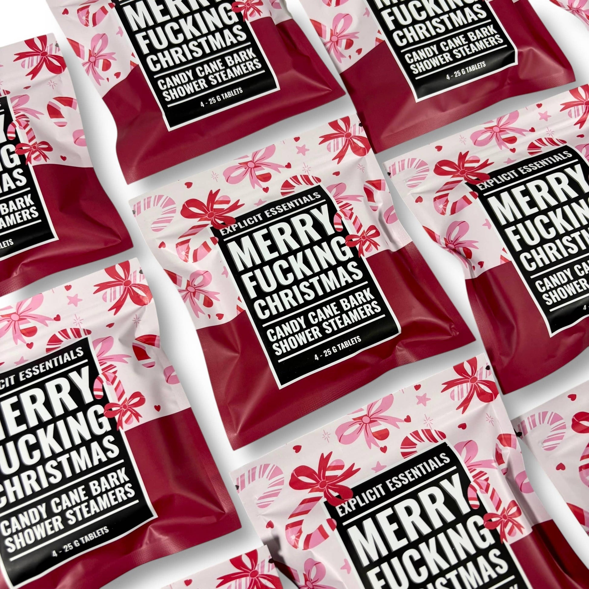 Multiple packages of 'Merry Fucking Christmas' candy cane bark shower steamers with red and white design.